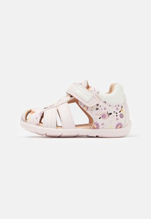 Light pink sandals with straps, featuring a floral pattern and cutouts, secured by a Velcro strap. Rubber sole for grip and comfort.