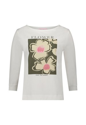 Hvid langærmet t-shirt med et blomsterprint med pink accenter på en mørkegrøn baggrund og teksten "smag blomsten."