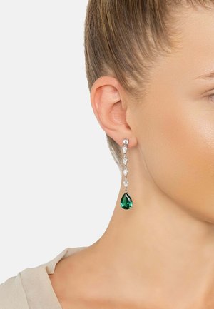 Emerald green teardrop earrings with silver accents and clear gemstone embellishments, featuring a dangling, elongated design.