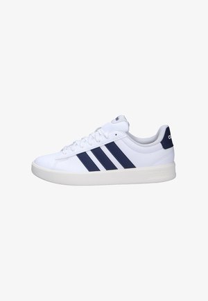 White low-top sneaker with navy blue Adidas stripes, white sole, and laces, viewed from the outer side.
