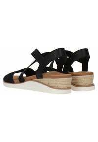 Sandalias de cuña negras con tiras cruzadas, que presentan un upper texturizado, un acento de yute trenzado y una suela gruesa de goma blanca.