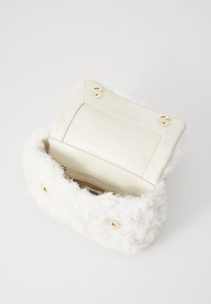 White faux fur handbag with a smooth cream interior. Features gold hardware and a zippered pocket inside. Closure with two gold buttons.