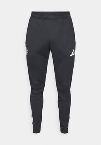 Sorte treningsbukser med strikk i midjen, glidelåslommer på siden og hvite Adidas-striper langs sidene. Har en logo på låret.