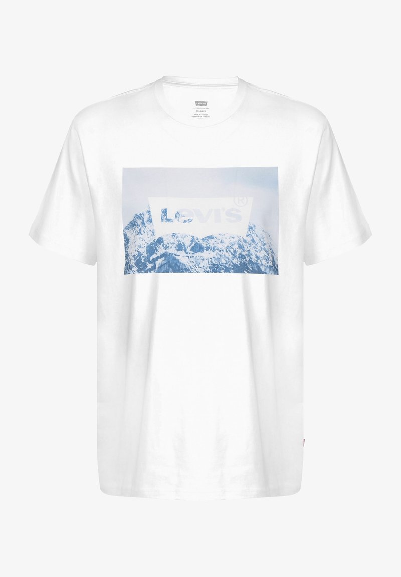 T-shirt blanc en coton avec un graphisme de montagne bleue et le logo Levi's au centre. Manches courtes, coupe décontractée et col rond.