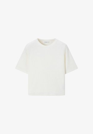 T-shirt blanc uni à manches courtes avec col rond et ourlet droit, présenté sur un fond blanc.