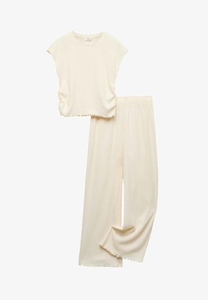 Cream-colored soft knit sleeveless top with matching wide-leg pants, featuring ruffled hems on both pieces.