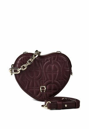 Heart-shaped burgundy leather bag with quilted pattern, gold-tone chain and hardware, and detachable matching strap.