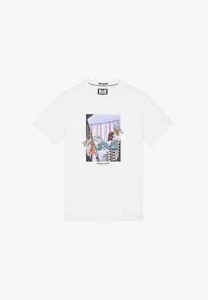 White cotton t-shirt featuring a graphic print of hanging sneakers in various colors. The design includes a cityscape and text below.