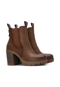 Stivali ankle in pelle marrone con tacco spesso, pannelli laterali elasticizzati e linguette per il tallone. Suola in gomma texturizzata per una maggiore aderenza e durata.
