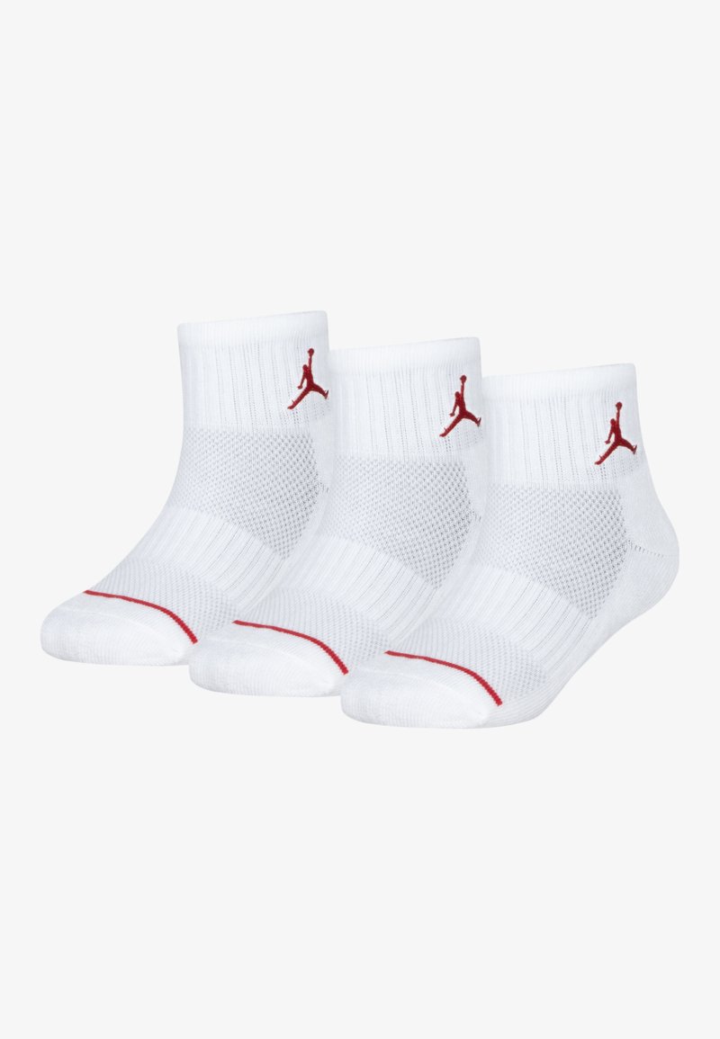 Calcetines tobilleros blancos con detalles en rojo, que presentan puños acanalados y paneles de malla para transpirabilidad. Incluye el icónico logo rojo de Jumpman.