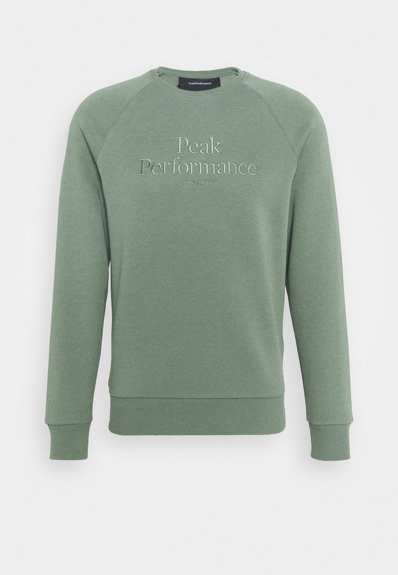 Sweat-shirt vert avec poignets et ourlet côtelés, arborant le logo brodé "Peak Performance" et la date de création 1936 sur le devant.