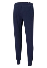 Granatowe spodnie dresowe wykonane z miękkiego materiału, z elastyczną talią i ściągaczami przy kostkach, o smukłym kroju zapewniającym komfort.