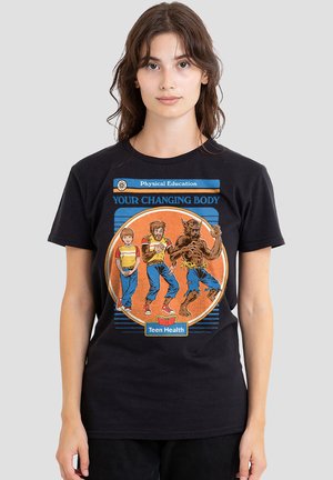 Young person wearing black t-shirt with illustration showing boy's transformation into a werewolf titled "Your Changing Body" for teen health.