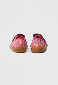 Pink children's shoes with a floral pattern, featuring a soft texture, velcro strap closure, and a flexible brown rubber sole.