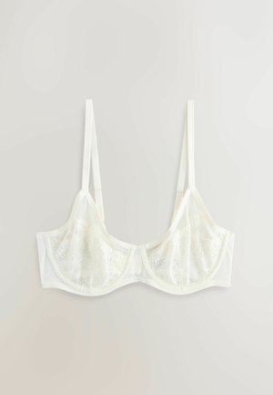 Baltas nėriniuotas liemenėlė su lankeliais, plonomis reguliuojamomis petnešėlėmis ir pusiau permatomais gėlių rašto nėrinių kaušeliais, išdėstyta ant šviesios fono.