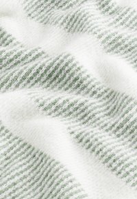 Woven fabric featuring alternating green and white stripes, with a soft, textured finish and visible fuzzy fibers creating depth.