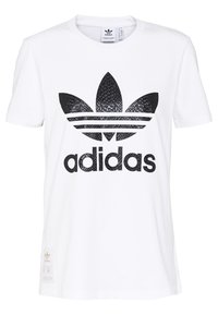 Biała bawełniana koszulka z dużym czarnym logo Adidasa z wzorem w wężową skórę oraz trzema czarnymi paskami poniżej. Metka w lewym dolnym rogu.