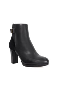 Black leather ankle boot with a smooth finish, pointed toe, and block heel. Features side elastic panel and a gold accent at the heel.