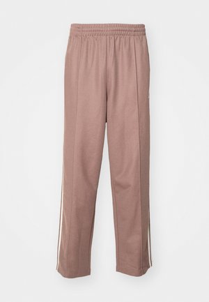 Light pink athletic pants with an elastic waistband, side stripes, and a straight-leg design. Made from soft, stretchy material.