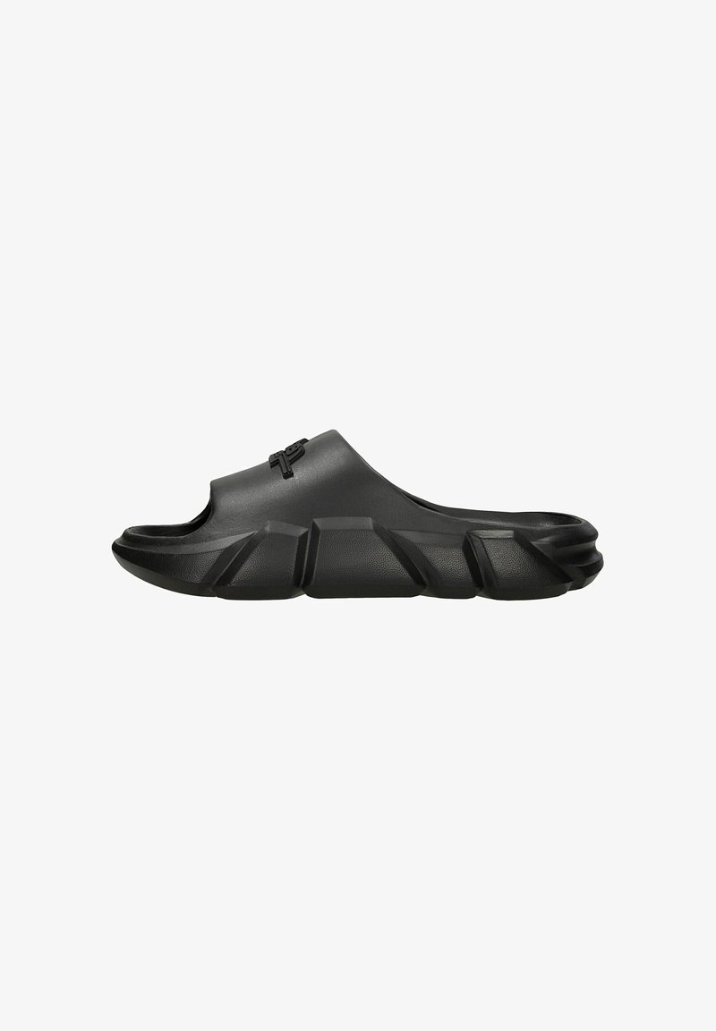 Black slide sandal featuring a smooth, matte finish, open toe, and thick, ridged sole for support and grip. Minimalist design with logo accent.