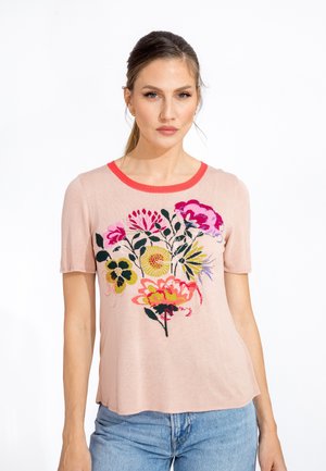 Short-sleeve pink top with a round neckline and vibrant floral embroidery in yellow, pink, and black. Soft texture, relaxed fit.
