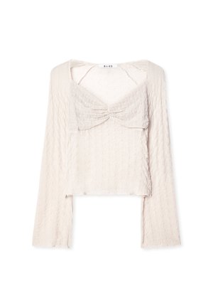 Dolga majica s kratkim krojem v svetlo bež barvi, ki se ponaša z teksturiranim valovitom vzorcem in zbranim sprednjim delom. Mehka, lahka tkanina s kvadratnim izrezom.