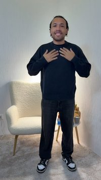 Μαύρο πουλόβερ και σκούρο τζιν που φοριέται από ένα άτομο που στέκεται, με τα χέρια στο στήθος. Στο φόντο διακρίνονται μια ανοιχτού χρώματος καρέκλα και ένα μικρό τραπέζι.