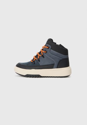 Baskets montantes en matériau synthétique bleu foncé et noir, avec des lacets orange, un col rembourré et une semelle extérieure crème robuste avec un motif texturé.