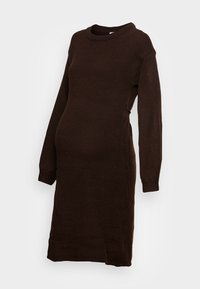 Brun stickad mammaklänning med rund halsringning, långa ärmar och en avslappnad passform. Har ribbade manschetter och en knälång nederkant.