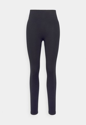 Svart ribbestrikkede leggings med høy midje, tettsittende design og jevn tekstur. Ingen synlige mønstre eller feste detaljer.