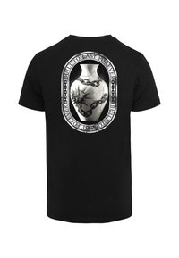 Black cotton t-shirt with a large graphic on the back depicting a cracked vase with chains, featuring spikes and text in circular design.