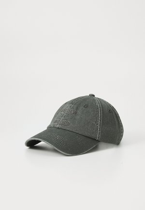 Dark green washed cotton baseball cap with curved brim and stitched ventilation holes on white background.