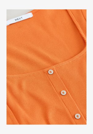 Ribbed orange top featuring a scoop neckline and white button accents along the front placket. Label shows "NEXT" at the neckline.