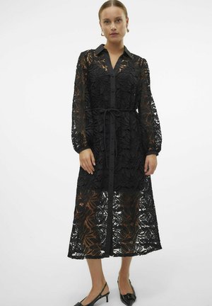 Black lace dress featuring a button-up front, long sleeves, and a waist tie. Floral pattern with sheer sections at the hem and sleeves.