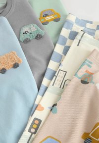 Two sweatshirts and two pairs of pants, featuring embroidered cars, pastel colors, checkered patterns, and city-themed graphics.