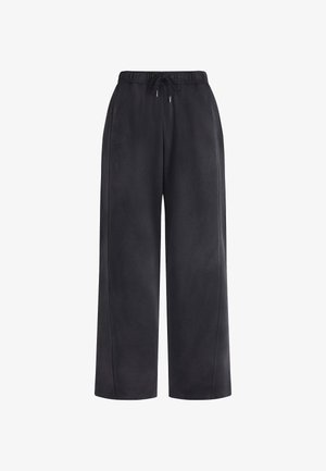 Pantalons de survêtement noirs à jambes larges avec une taille élastique et un cordon de serrage ajustable. Texture douce avec un subtil detailing latéral.