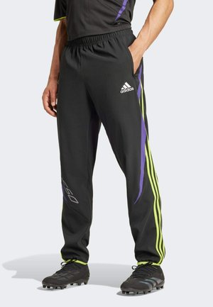 Schwarze Sporthosen mit lila und limonengrünen Akzenten, elastischem Bund und Seitentaschen. Mit einem Logo am linken Oberschenkel.