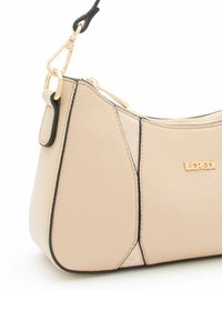 Beige leather handbag with a curved shape, black trim, gold hardware, and a zip closure. Features the brand name "LCREDI" embossed on the side.