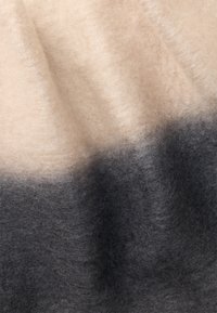 Tejido de mezcla de lana con un degradado de beige claro a gris oscuro. Superficie suave y texturizada con una apariencia borrosa, creando profundidad visual.
