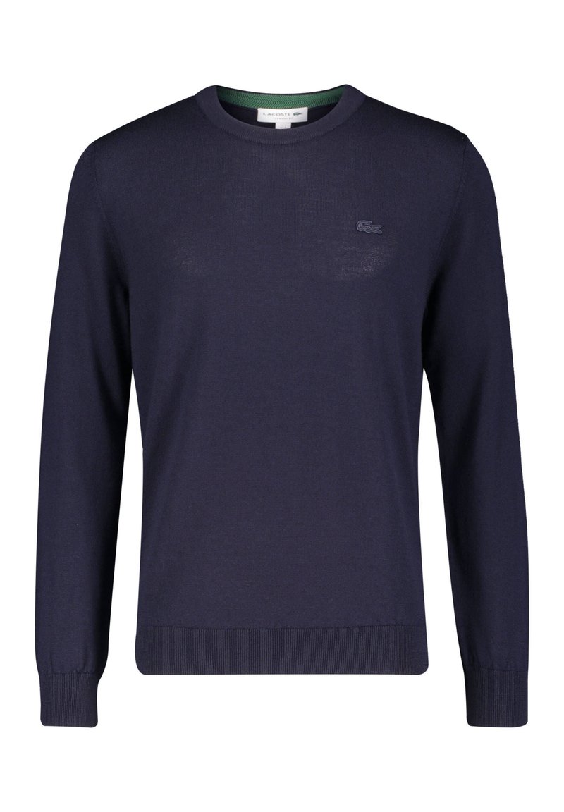 Navy blue knit sweater with a round neckline, ribbed cuffs, and hem. Features a small embroidered logo on the chest and a green inner collar.