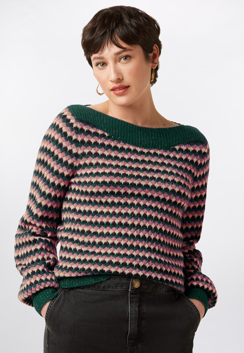 Multicolored knitted sweater featuring a geometric pattern in pink, green, and cream. Oversized green collar and cuffs, with ribbed texture.