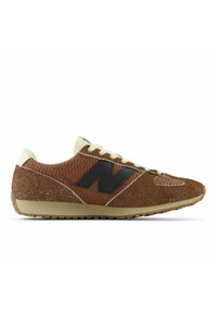 Brown suede and mesh running shoe with black side logo, beige laces, and textured beige sole, shown in left profile view.