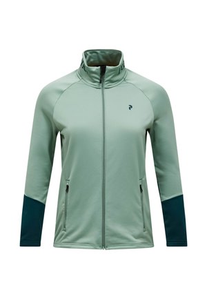 Giacca verde chiaro con zip frontale, colletto alto, maniche lunghe e dettagli verde scuro sulle maniche. Presenta due tasche laterali con cerniere.