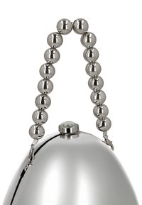 Sølvfarvet clutchtasken formet som et æg med et perlebesat metalhåndtag og en klar ædelsten i toppen. Glat tekstur med en blank finish.