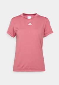 Rosa polyester t-shirt med korta uppvikta ärmar, rund halsringning och en liten vit logotyp på bröstet. Slät textur, avslappnad passform.