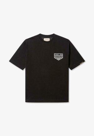 Melnas īsām piedurknēm T-krekls no kokvilnas auduma, ar balto "Pas de Monaco" logo un šaha laukumu rakstu kreisajā krūtīs.