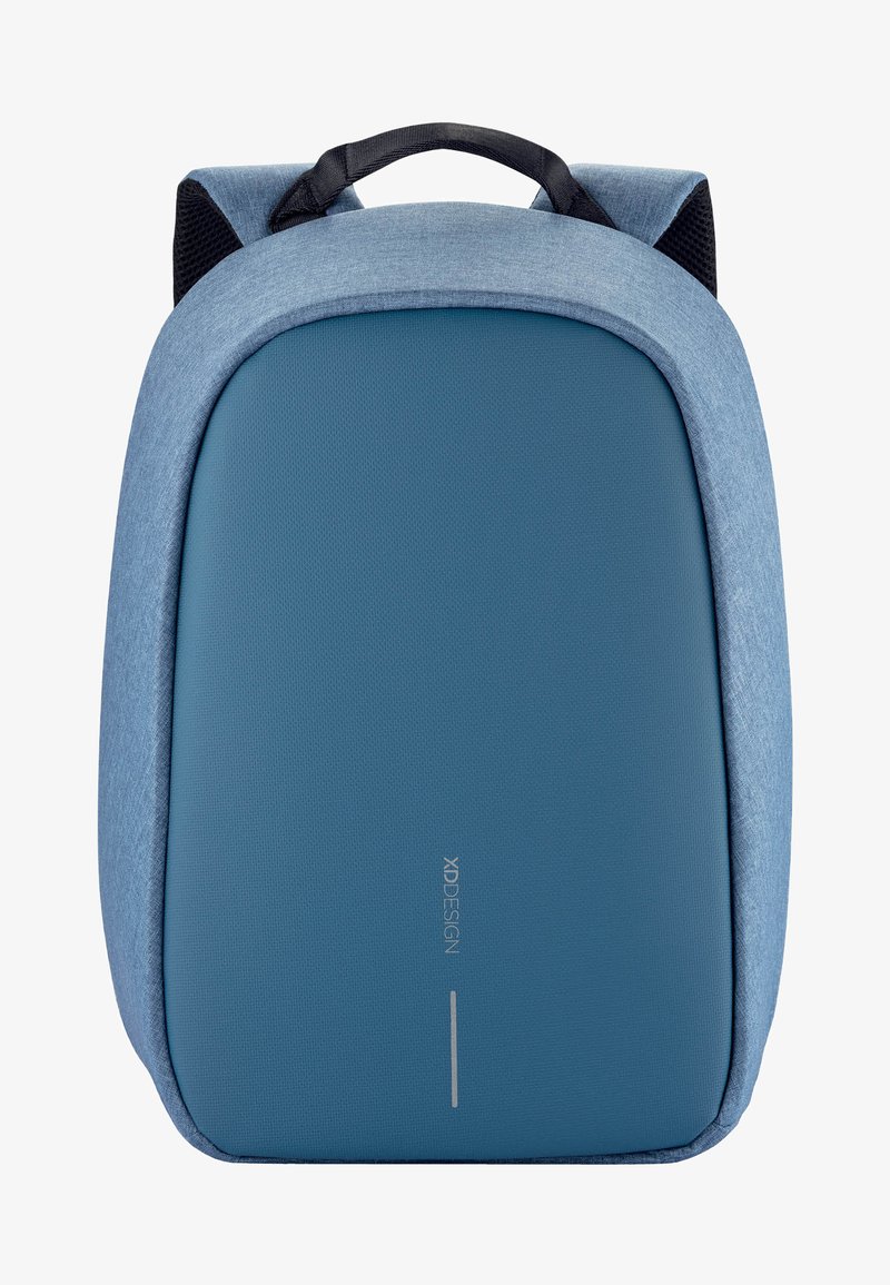 Sac à dos en tissu bleu avec une surface texturée, un design épuré et une forme arrondie. Il dispose d'une poignée supérieure et de bretelles rembourrées.