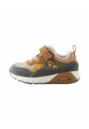 Multicolored sneaker featuring a mix of tan, green, and gray materials. Velcro strap, mesh panels, and lion embroidery on the side.