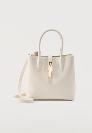 Cream leather handbag with dual top handles, a long shoulder strap, and a gold-tone clasp closure at the center front.