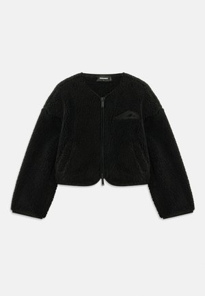 Black zip-up jacket made of textured sherpa fabric, featuring a round neck, long sleeves, and a small pocket on the left chest.